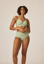 Voorzijde van vrouw die de side smoother bh en high waist slip in de kleur pale greenshield van het merk Naturana draagt