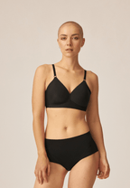 Voorzijde van vrouw die de side smoother bh en high waist slip in de kleur zwart van het merk Naturana draagt