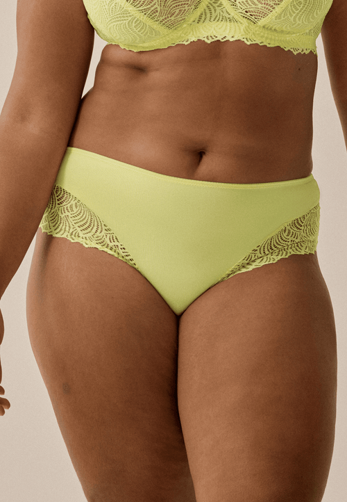 Voorzijde van vrouw die de hipster met gerecycled kant in de kleur sunny lime van het merk Naturana draagt