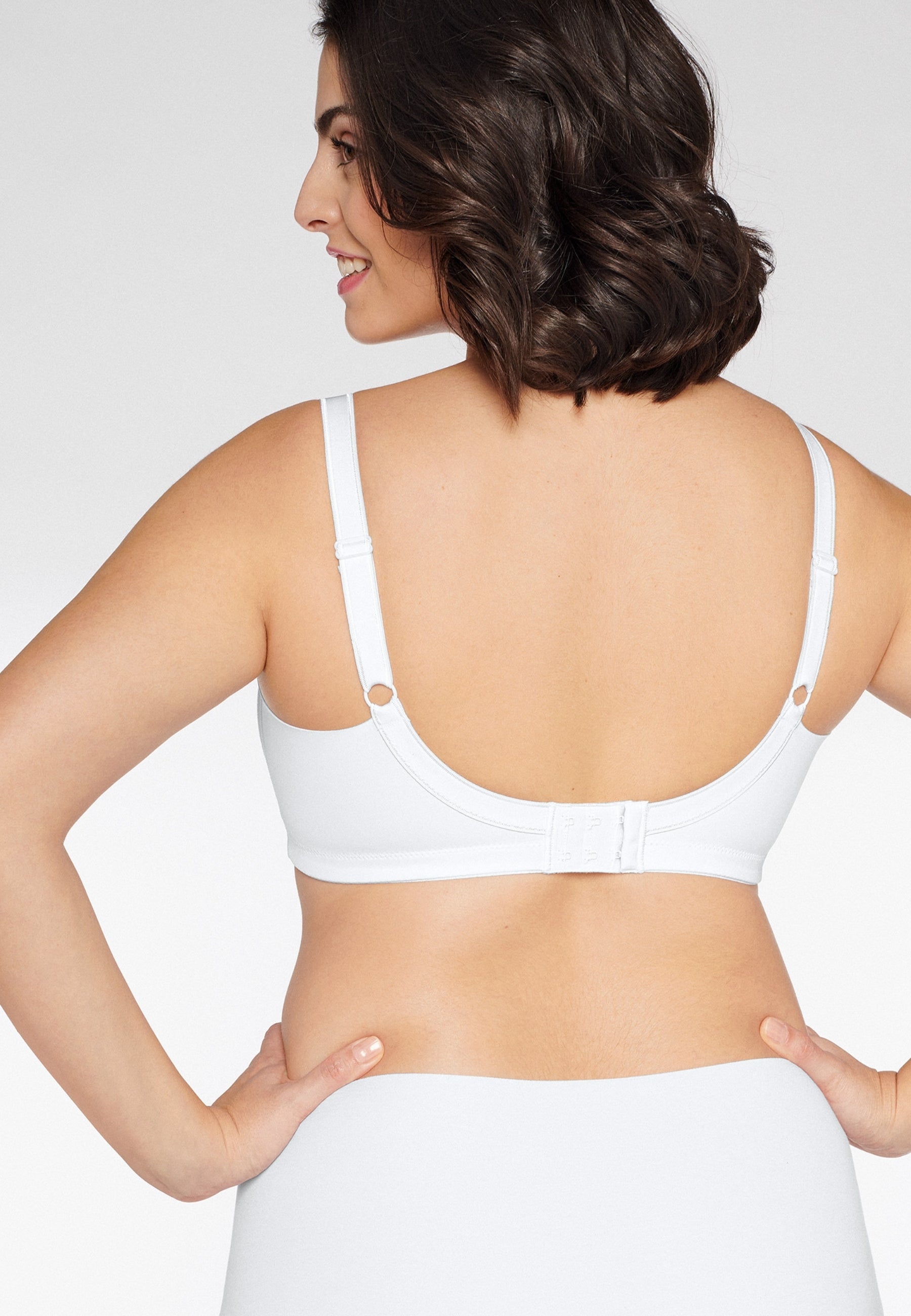 Achterzijde van vrouw die de minimizer bh met side smoother in de kleur wit van het merk Naturana draagt