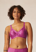 Voorzijde van vrouw die de minimizer bh met bloemenpatroon in de kleur purple orchid van het merk Naturana draagt