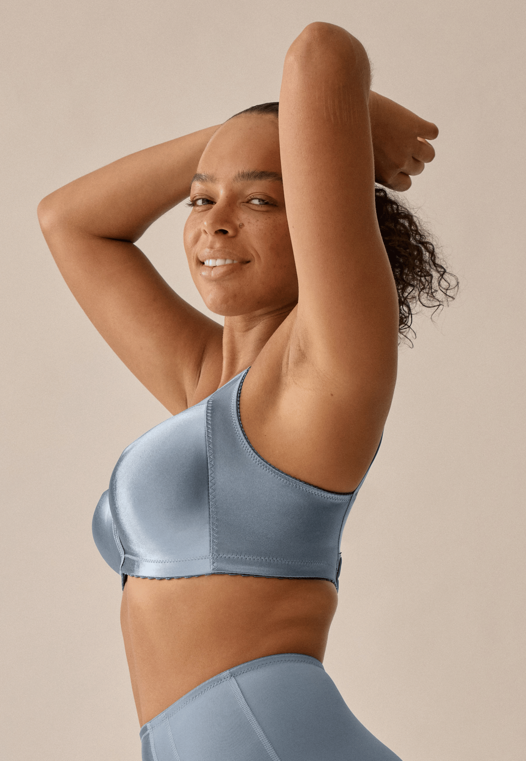 Zijde van vrouw die de minimizer bh in de kleur moonlight blue van het merk Naturana draagt