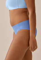 Zijde van vrouw die de one size slip in de kleur marina blue van het merk Naturana draagt