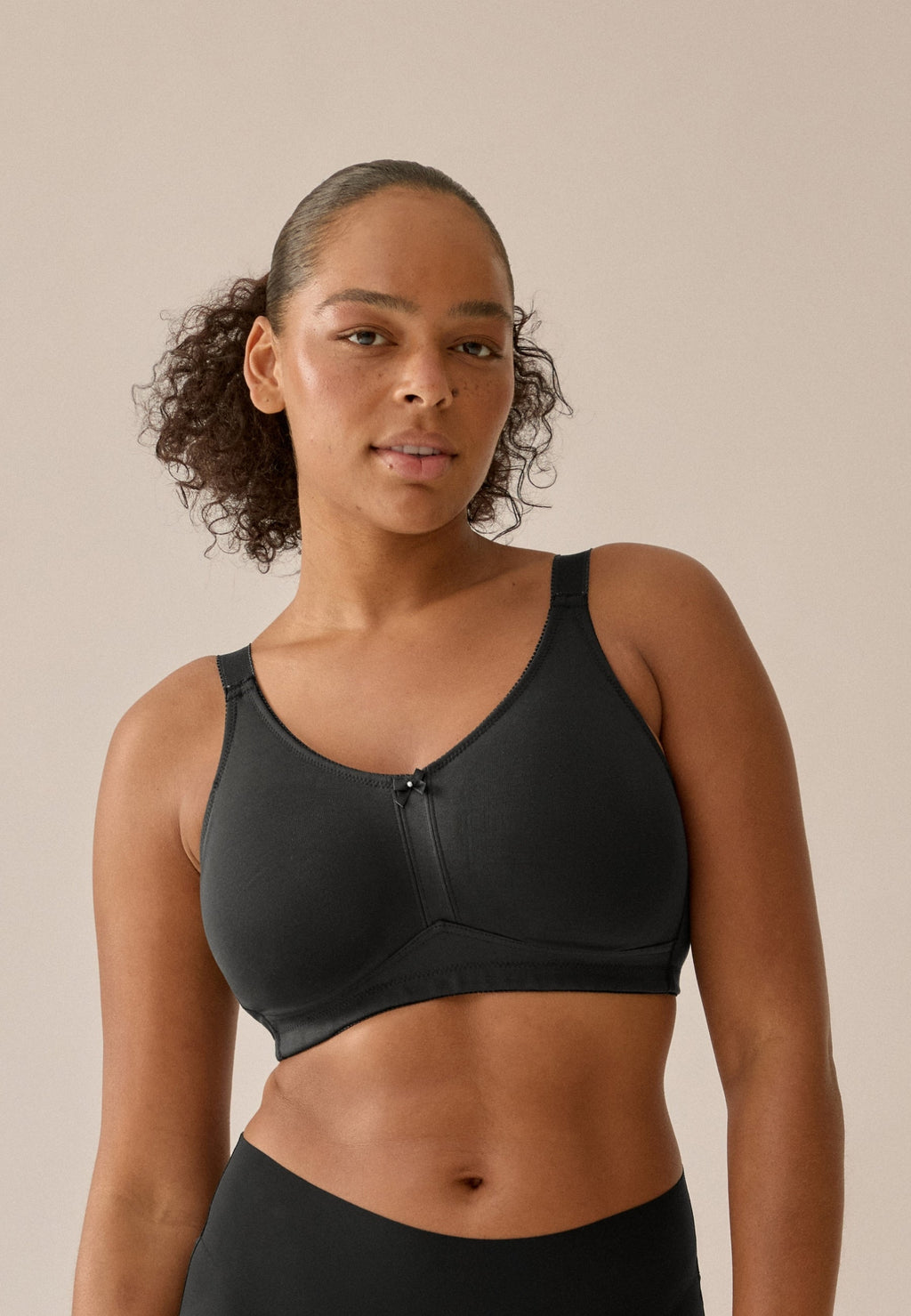Voorzijde van vrouw die de prothese bh in de kleur zwart van het merk Naturana draagt