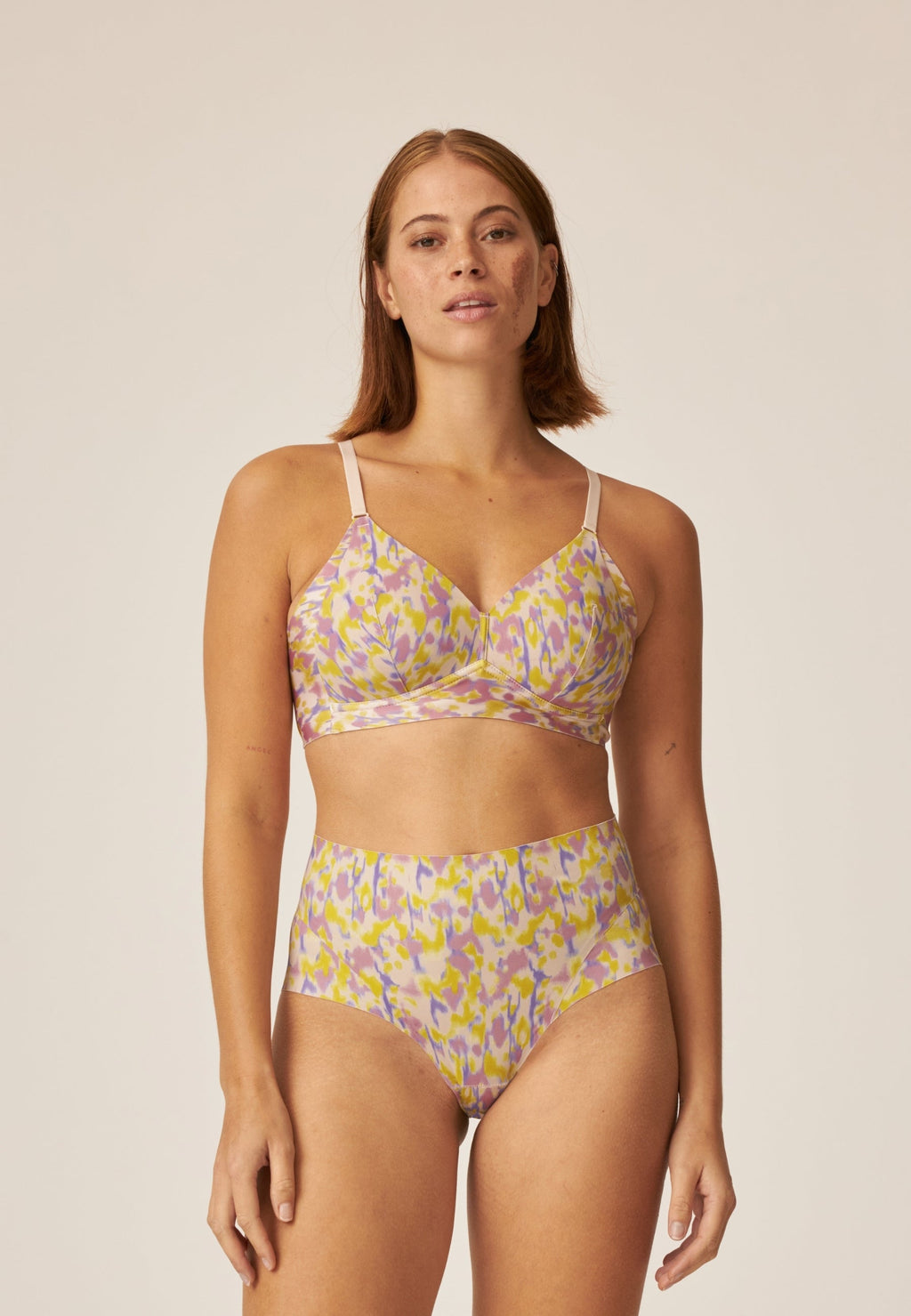 Voorzijde van vrouw die de side smoother bh en high waist slip in de kleur smoked orchid print van het merk Naturana draagt