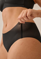 Zijde van vrouw die de slip one size in de kleur zwart van het merk Naturana draagt