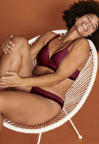 Voorzijde van vrouw die de soft bh met strepen en slip met strepen in de kleur burgundy van het merk Naturana draagt