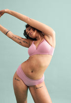 Voorzijde van vrouw die de soft bh en slip met glansband in de kleur smoked orchid van het merk Naturana draagt