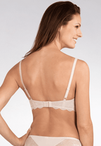 Achterzijde van vrouw die de soft bh met kant in de kleur beige van het merk Naturana draagt